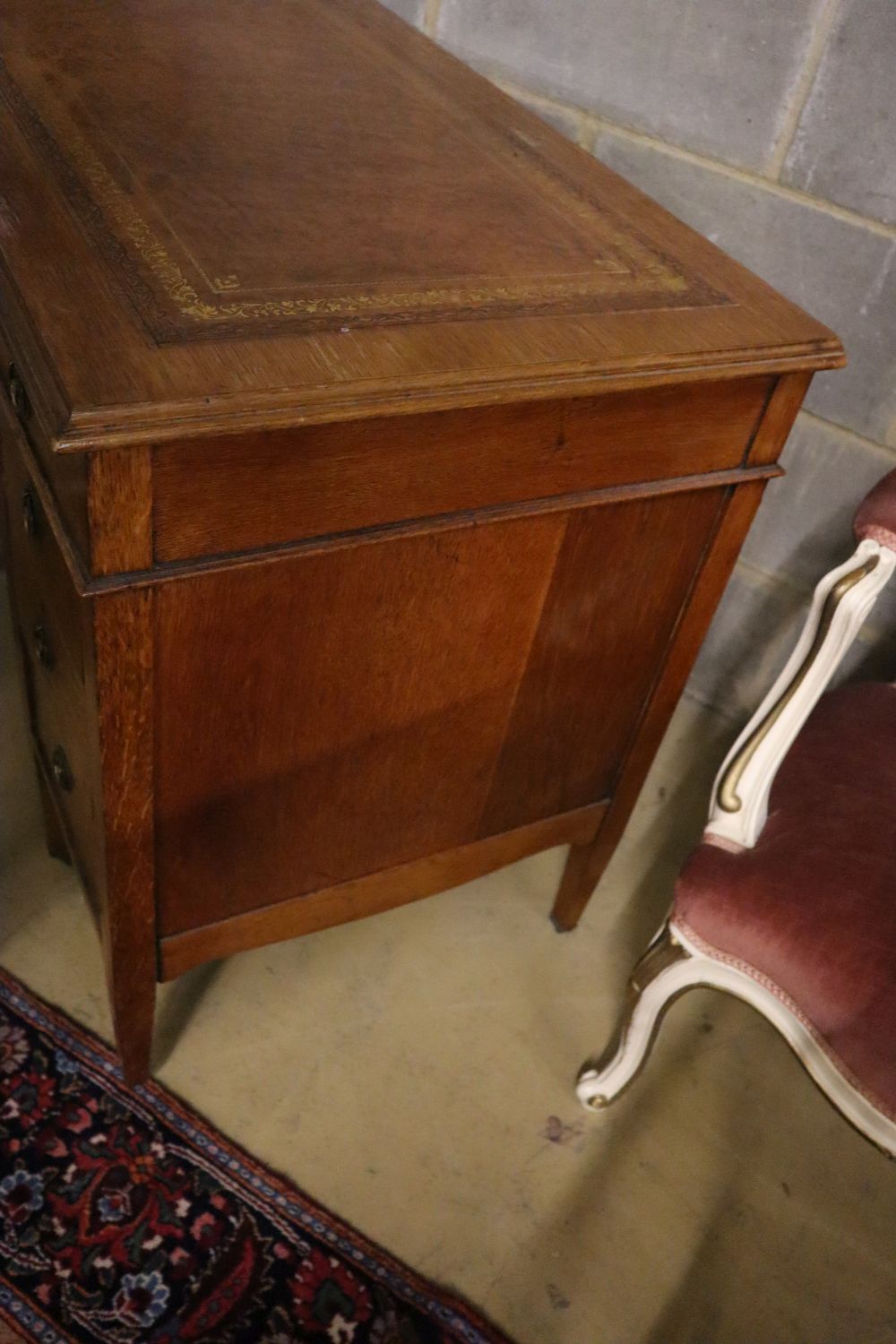 A late Victorian oak kneehole desk, width 90cm depth 53cm height 75cm